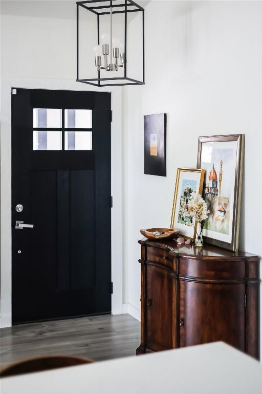 1415 Mearns Meadow Blvd, Austin, TX 78758 - foyer with wood finished floors, baseboards, and a chandelier