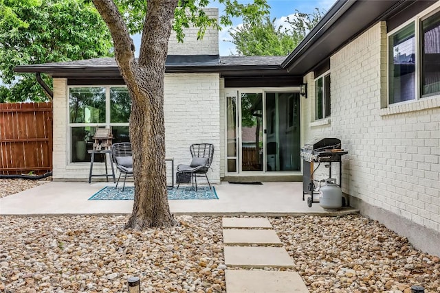 1415 Mearns Meadow Blvd, Austin, TX 78758 - back of house with a patio, brick siding, fence, and a chimney