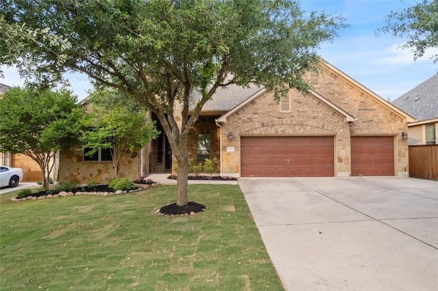 2420 Champions Corner Dr, Leander, TX 78641 - view of front of home with driveway, a front yard, an attached garage, brick siding, and stone siding