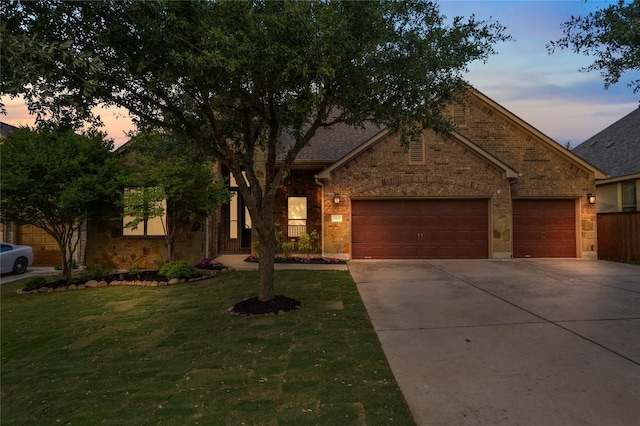 2420 Champions Corner Dr, Leander, TX 78641 - view of front of home featuring concrete driveway, an attached garage, a front yard, and brick siding
