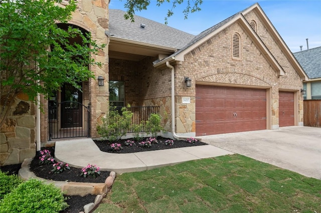 2420 Champions Corner Dr, Leander, TX 78641 - view of front of property with a garage, driveway, a shingled roof, stone siding, and brick siding