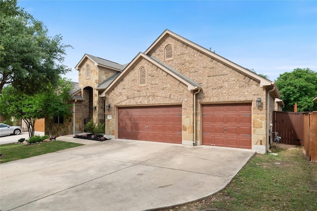 2420 Champions Corner Dr, Leander, TX 78641 - view of front facade featuring stone siding, driveway, and a garage