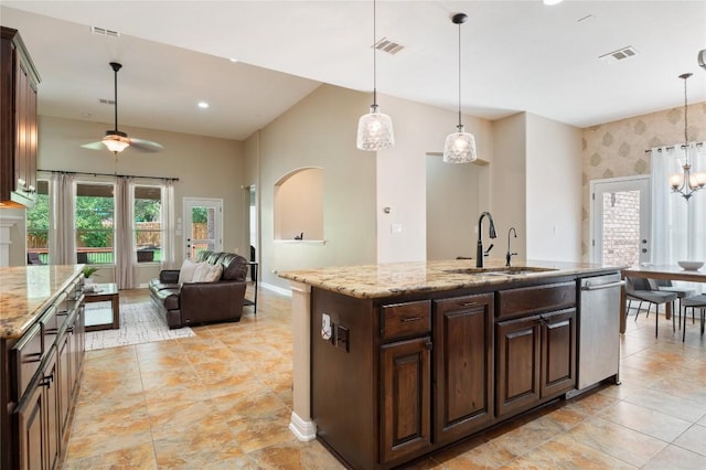 2420 Champions Corner Dr, Leander, TX 78641 - kitchen featuring stainless steel dishwasher, a sink, ceiling fan, open floor plan, and pendant lighting