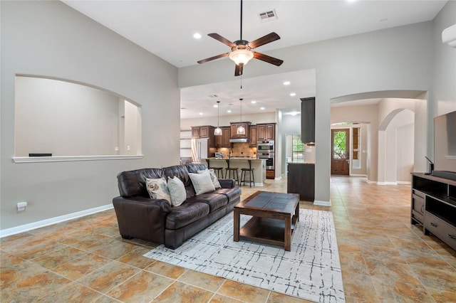 2420 Champions Corner Dr, Leander, TX 78641 - living area featuring ceiling fan, arched walkways, baseboards, and recessed lighting