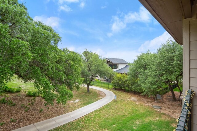 surrounding community featuring fence and a lawn