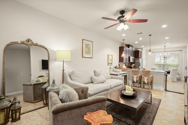 living room featuring ceiling fan with notable chandelier, recessed lighting, and visible vents