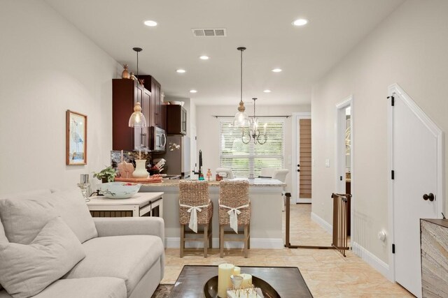living area featuring recessed lighting, a chandelier, and visible vents