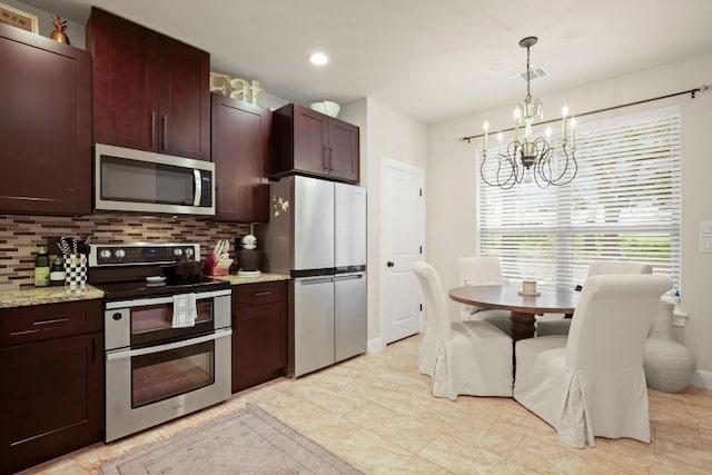 kitchen with visible vents, appliances with stainless steel finishes, backsplash, and a notable chandelier