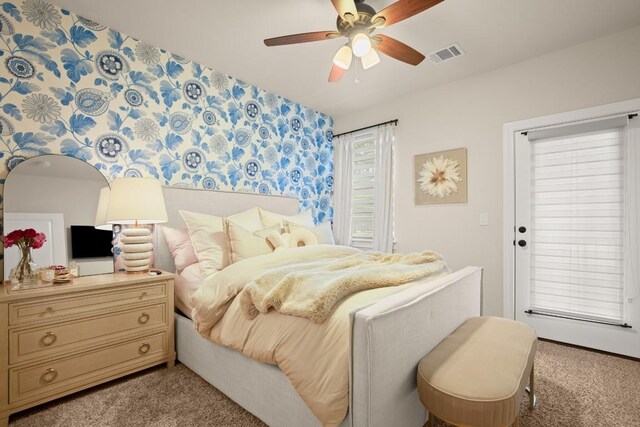 bedroom featuring light carpet, a ceiling fan, and visible vents