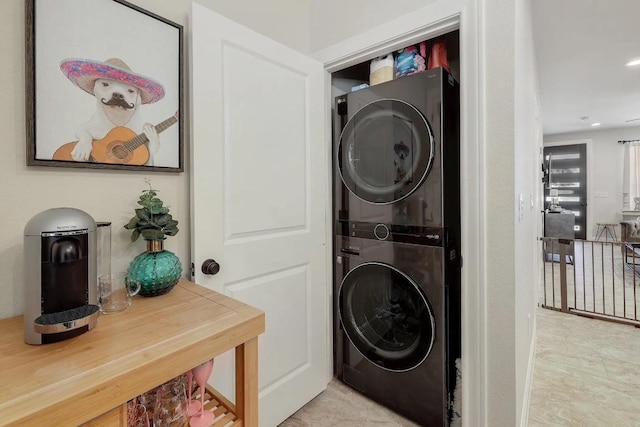 laundry room with recessed lighting, laundry area, and stacked washer and dryer