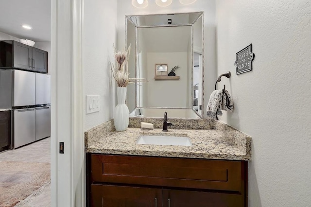 581 Demarett Dr, Point Venture, TX 78645 - bathroom with vanity and a textured wall