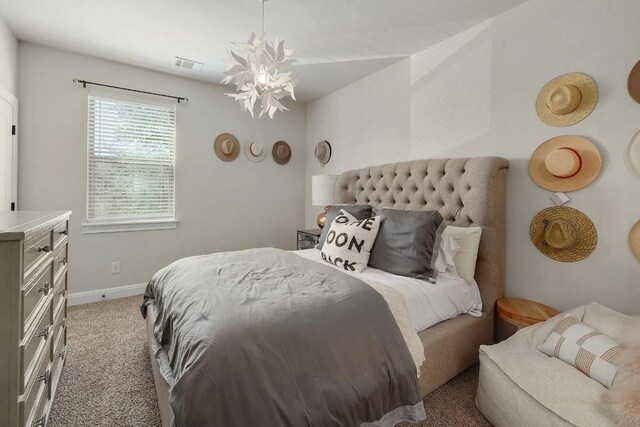 bedroom featuring an inviting chandelier, baseboards, light colored carpet, and visible vents