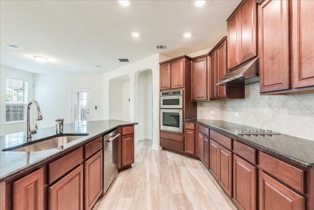 kitchen featuring visible vents, a sink, appliances with stainless steel finishes, and under cabinet range hood