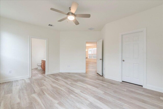 unfurnished bedroom featuring baseboards, light wood finished floors, and visible vents