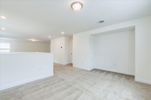carpeted empty room with recessed lighting, baseboards, and visible vents