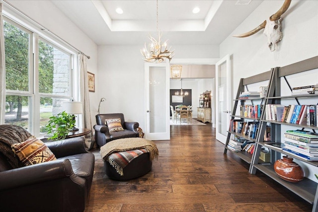 2201 Live Oak Rd, Leander, TX 78641 - sitting room featuring a chandelier, hardwood / wood-style flooring, a raised ceiling, and recessed lighting