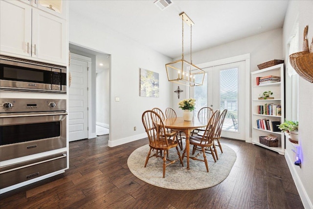 dining room with baseboards, visible vents, an inviting chandelier, and dark wood finished floors