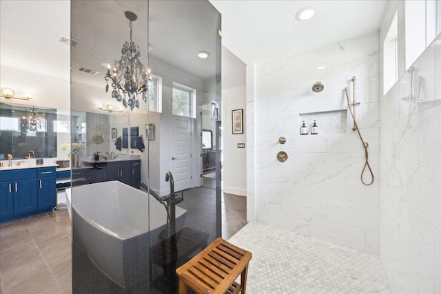full bath featuring visible vents, a walk in shower, a freestanding bath, and a notable chandelier