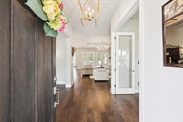 2201 Live Oak Rd, Leander, TX 78641 - foyer entrance with a chandelier, dark wood-type flooring, french doors, and a raised ceiling