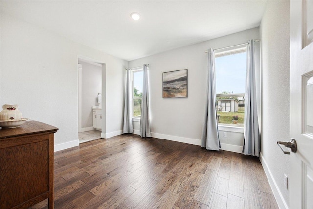 interior space featuring baseboards, recessed lighting, and wood finished floors