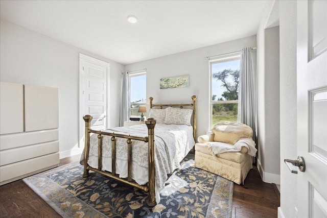2201 Live Oak Rd, Leander, TX 78641 - bedroom with multiple windows, wood finished floors, and baseboards