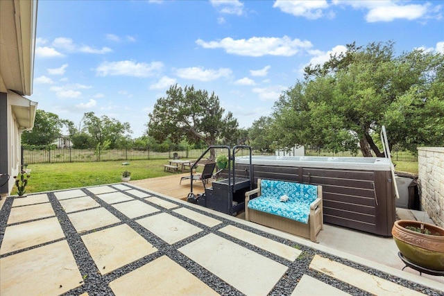 view of patio with a hot tub, fence, and a wooden deck