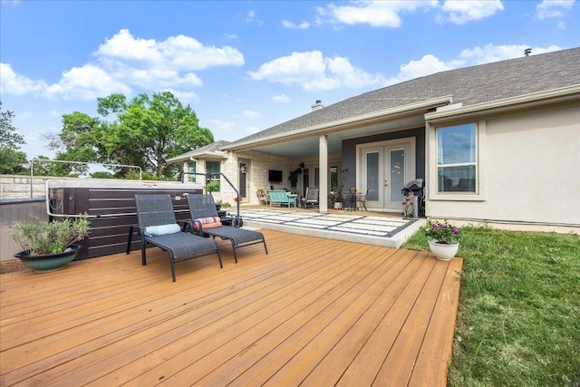 wooden deck with a patio and french doors