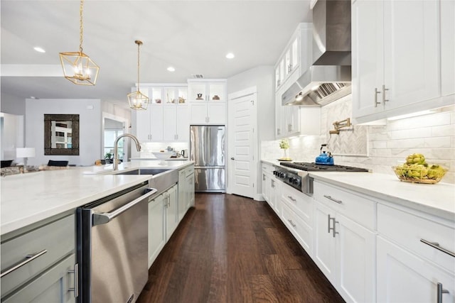 2201 Live Oak Rd, Leander, TX 78641 - kitchen featuring wall chimney exhaust hood, appliances with stainless steel finishes, a sink, glass insert cabinets, and backsplash