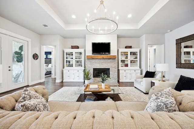 2201 Live Oak Rd, Leander, TX 78641 - living area with a raised ceiling, a chandelier, dark wood-style floors, and recessed lighting