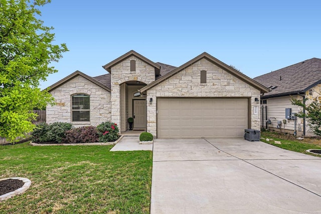 french country style house with concrete driveway, an attached garage, stone siding, and a front lawn