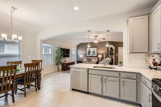 kitchen with appliances with stainless steel finishes, gray cabinets, and vaulted ceiling