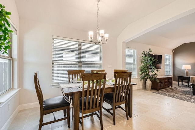 dining room featuring baseboards, a notable chandelier, light tile patterned floors, and vaulted ceiling