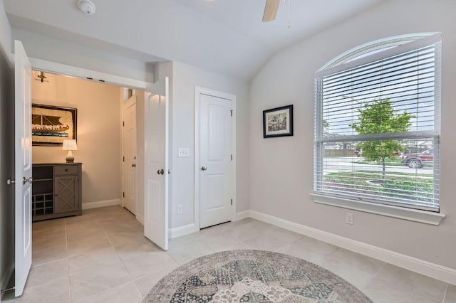 304 La Joya Pass, Leander, TX 78641 - bedroom featuring lofted ceiling, light tile patterned floors, baseboards, and ceiling fan