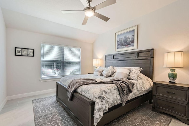 bedroom featuring baseboards, a ceiling fan, light tile patterned floors, and lofted ceiling