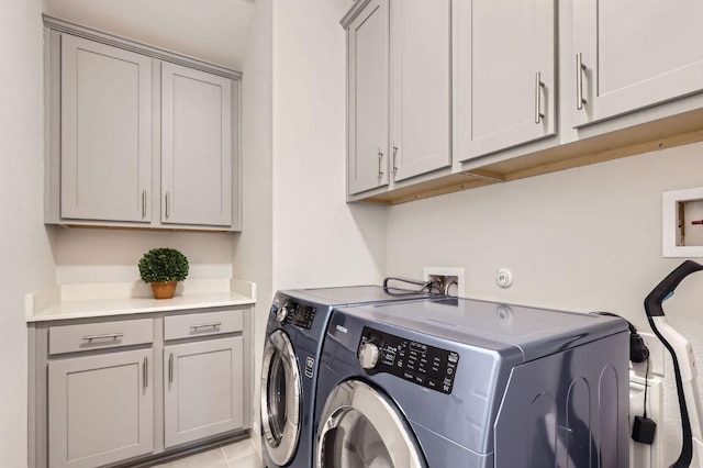 laundry room with cabinet space and washing machine and clothes dryer