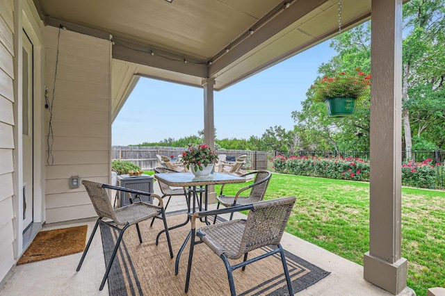 view of patio with outdoor dining area and a fenced backyard