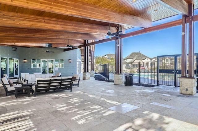 view of patio featuring fence, ceiling fan, and outdoor lounge area