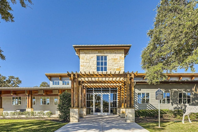 view of front of house featuring a pergola and stone siding