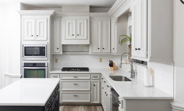 kitchen featuring backsplash, a kitchen island, light stone countertops, and stainless steel appliances