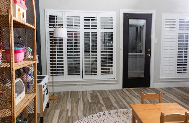 interior space with baseboards and wood finished floors