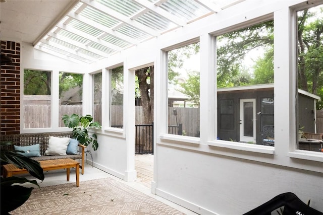 sunroom / solarium featuring vaulted ceiling and a wealth of natural light
