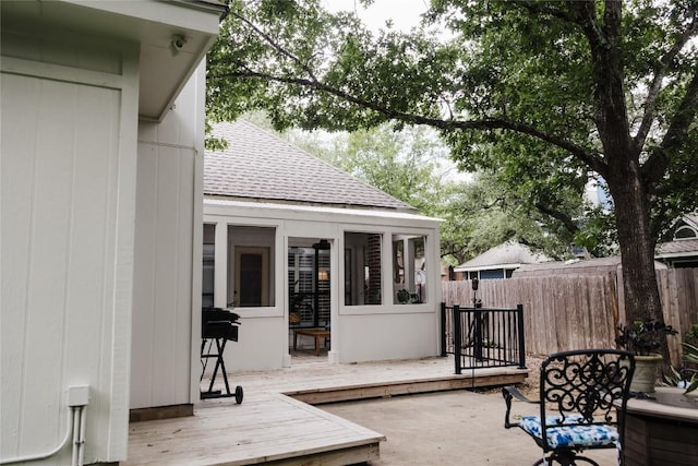 view of patio / terrace with a wooden deck and fence
