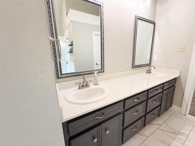 full bath featuring double vanity, a sink, and marble finish floor