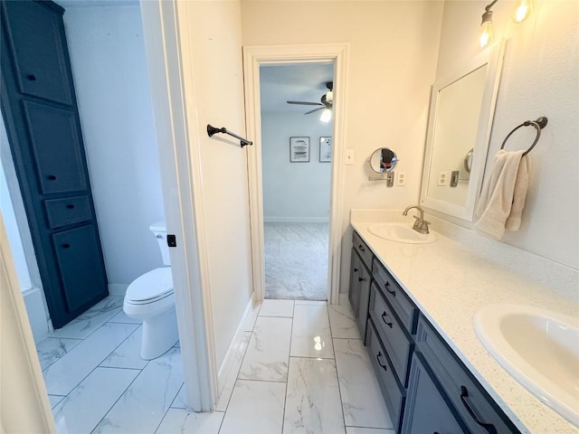 bathroom featuring double vanity, a sink, marble finish floor, and ceiling fan