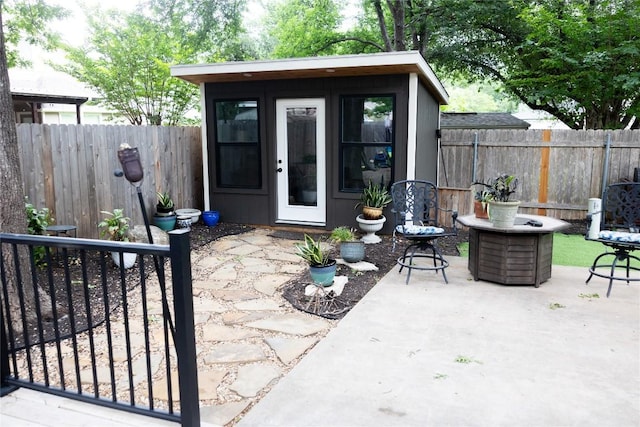 view of outdoor structure with a fenced backyard and an outbuilding