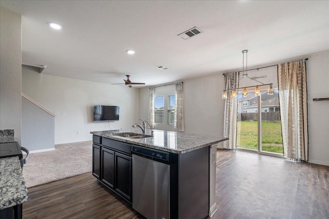 kitchen with a ceiling fan, stainless steel dishwasher, light stone countertops, a sink, and open floor plan