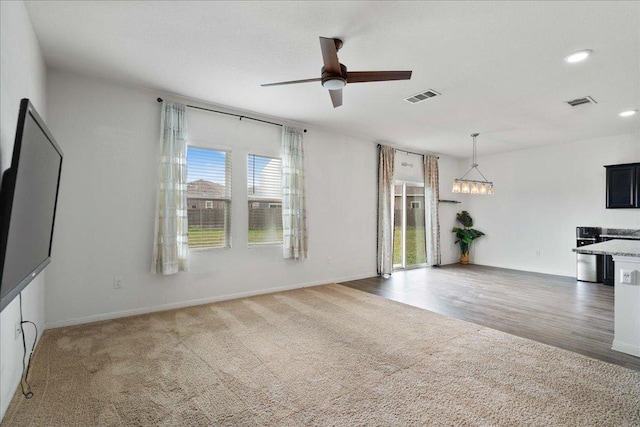 516 Peony Ct, Jarrell, TX 76537 - unfurnished living room with a ceiling fan, recessed lighting, baseboards, a chandelier, and carpet