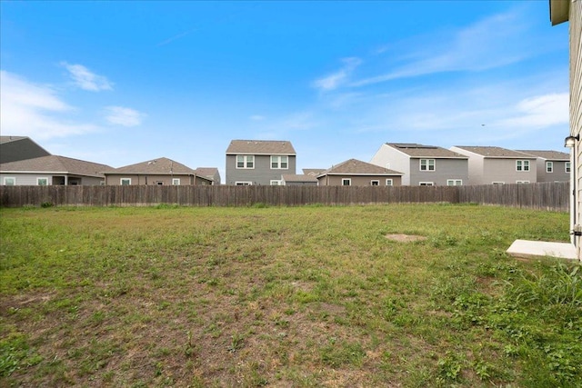 view of yard featuring fence and a residential view