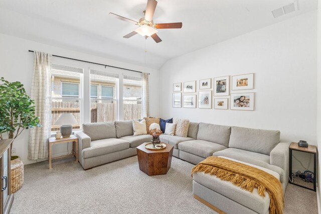 living area with visible vents, carpet flooring, and ceiling fan