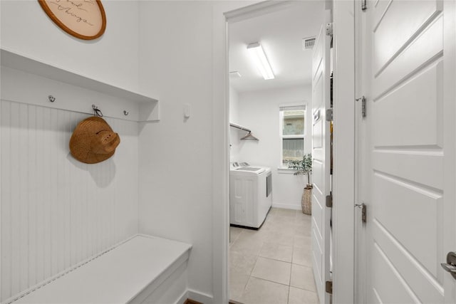 mudroom with separate washer and dryer, visible vents, and light tile patterned floors